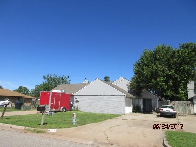 view of property exterior featuring fence and a lawn