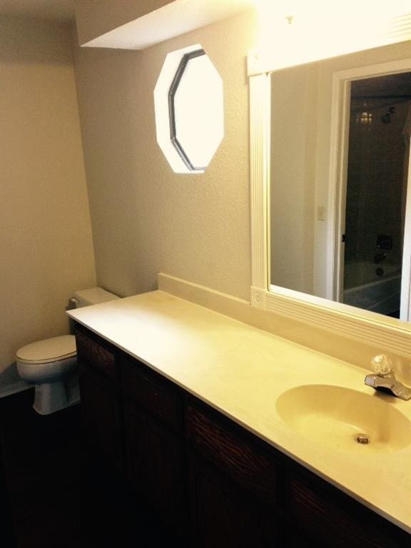 bathroom featuring a shower, vanity, a bathing tub, and toilet
