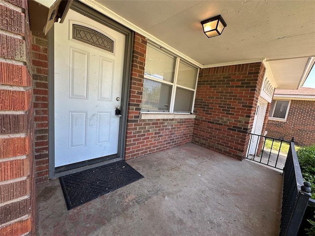 4445 NW 19th St, Oklahoma City, OK 73107 - view of exterior entry featuring a porch and brick siding