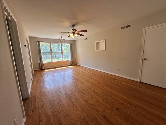 4445 NW 19th St, Oklahoma City, OK 73107 - unfurnished room with baseboards, visible vents, hardwood / wood-style flooring, and a ceiling fan