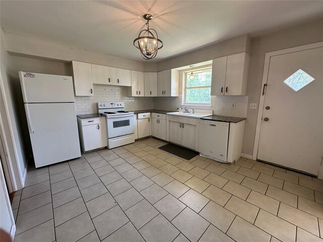 4445 NW 19th St, Oklahoma City, OK 73107 - kitchen with white appliances, white cabinetry, a sink, dark countertops, and backsplash