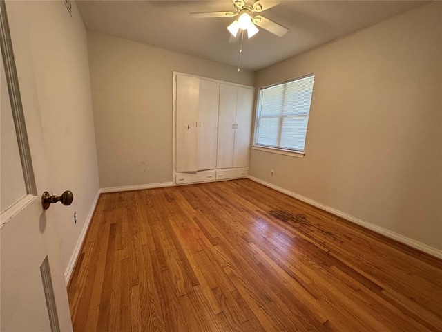 4445 NW 19th St, Oklahoma City, OK 73107 - unfurnished bedroom featuring ceiling fan, baseboards, and wood finished floors
