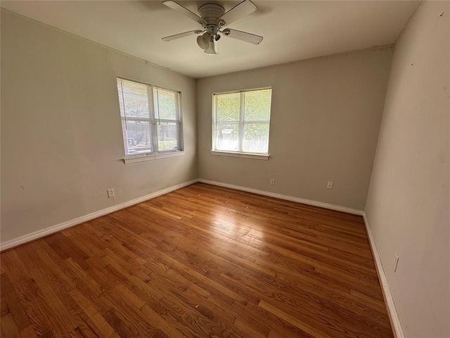 4445 NW 19th St, Oklahoma City, OK 73107 - unfurnished room with baseboards, a ceiling fan, and wood finished floors