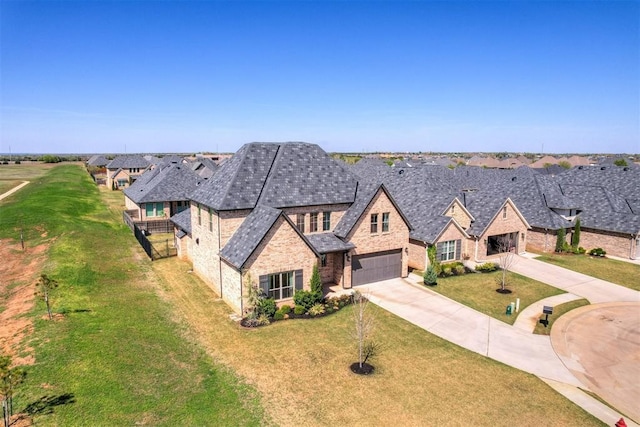 101 Pont Neuf Ct, Edmond, OK 73034 - view of front of home with stone siding, brick siding, a front lawn, a residential view, and driveway