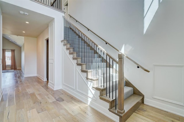 101 Pont Neuf Ct, Edmond, OK 73034 - stairs featuring recessed lighting, wood finished floors, and lofted ceiling