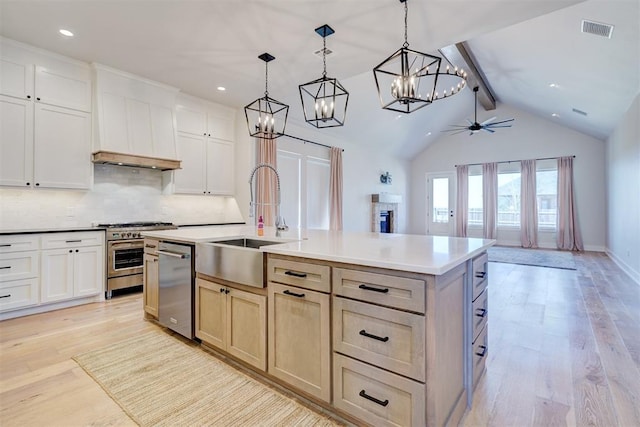101 Pont Neuf Ct, Edmond, OK 73034 - kitchen with tasteful backsplash, visible vents, stainless steel appliances, ceiling fan with notable chandelier, and a sink