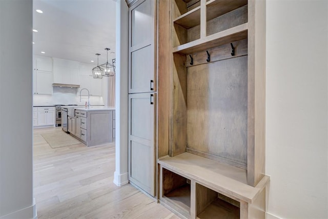 101 Pont Neuf Ct, Edmond, OK 73034 - mudroom featuring light wood-style flooring, a chandelier, baseboards, and recessed lighting