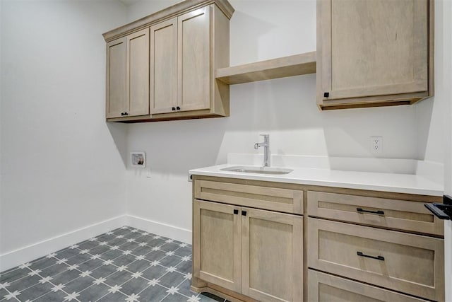101 Pont Neuf Ct, Edmond, OK 73034 - laundry area with baseboards, a sink, cabinet space, dark floors, and hookup for a washing machine