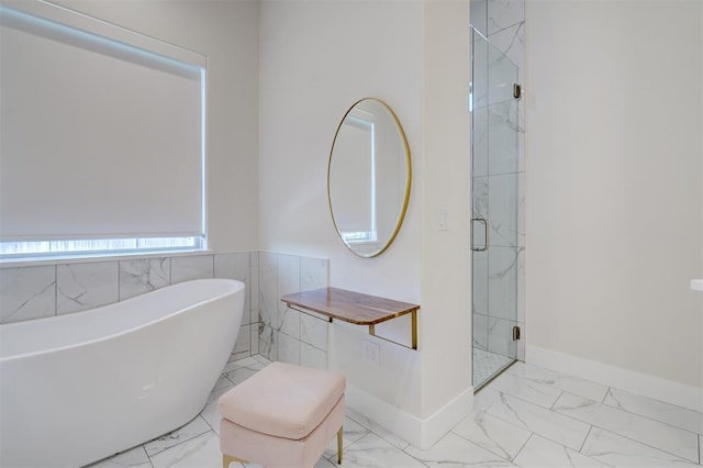 101 Pont Neuf Ct, Edmond, OK 73034 - bathroom featuring a shower stall, a soaking tub, marble finish floor, and baseboards