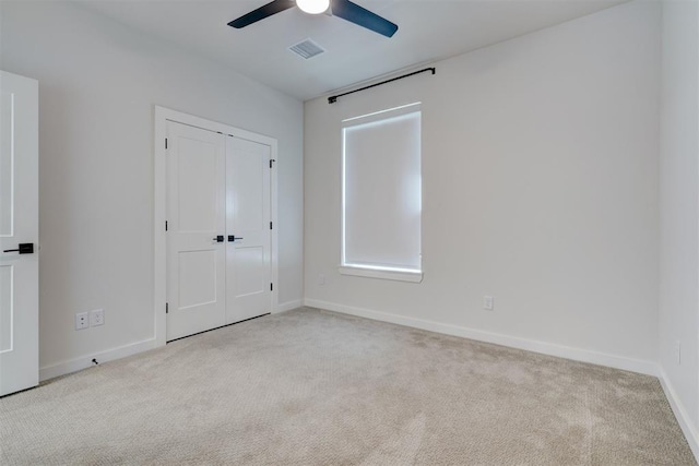 101 Pont Neuf Ct, Edmond, OK 73034 - unfurnished bedroom featuring ceiling fan, a closet, visible vents, carpet flooring, and baseboards