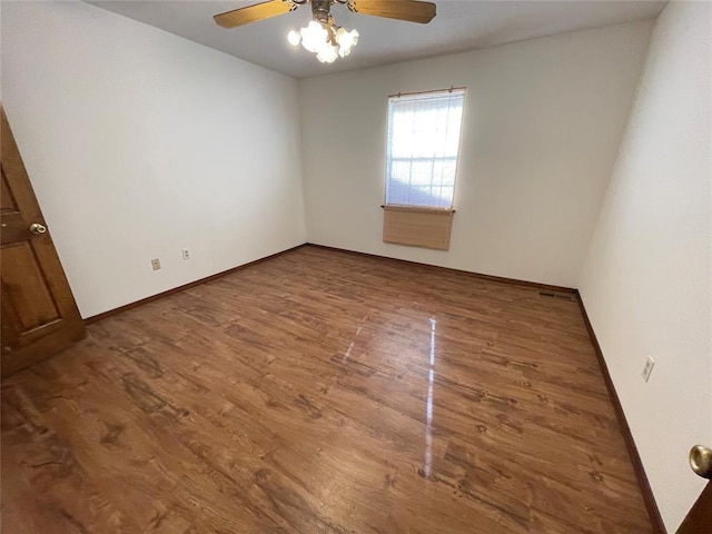 809 Tottingham Rd, Anadarko, OK 73005 - unfurnished room featuring wood finished floors, baseboards, and a ceiling fan