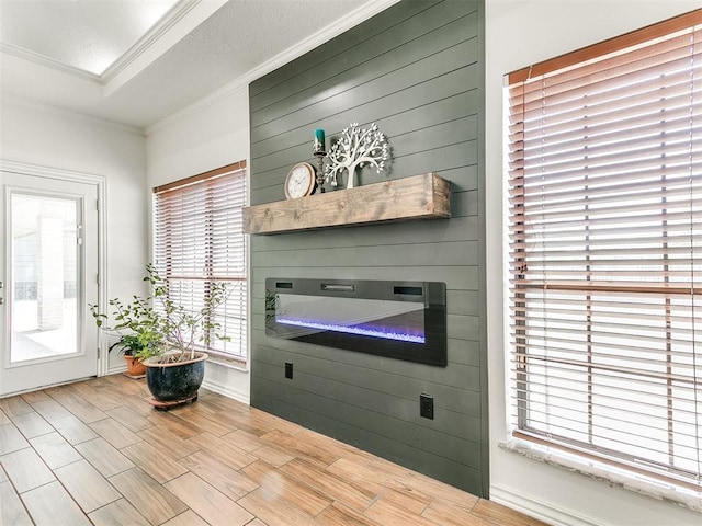 interior space with ornamental molding, wood finished floors, and a fireplace