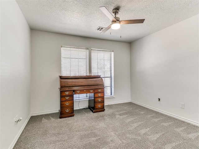 unfurnished office featuring a textured ceiling, ceiling fan, visible vents, and carpet floors