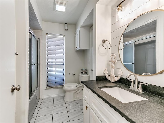 bathroom featuring shower / bath combination with glass door, vanity, and toilet