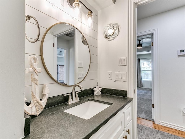bathroom featuring wood finished floors, vanity, and visible vents
