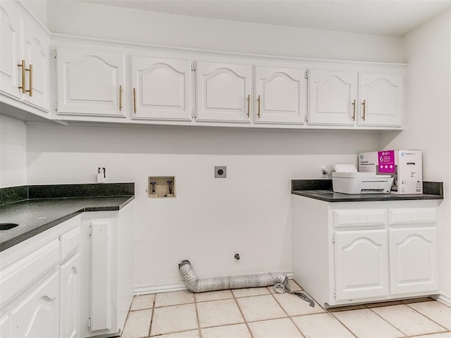 laundry room featuring electric dryer hookup, baseboards, light tile patterned floors, hookup for a washing machine, and cabinet space