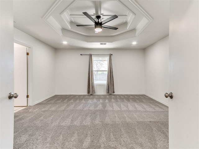 carpeted empty room with visible vents, baseboards, crown molding, and ceiling fan