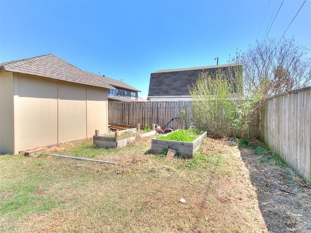 view of yard featuring a fenced backyard and a vegetable garden