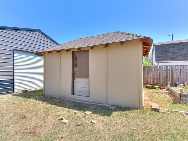 view of shed with fence