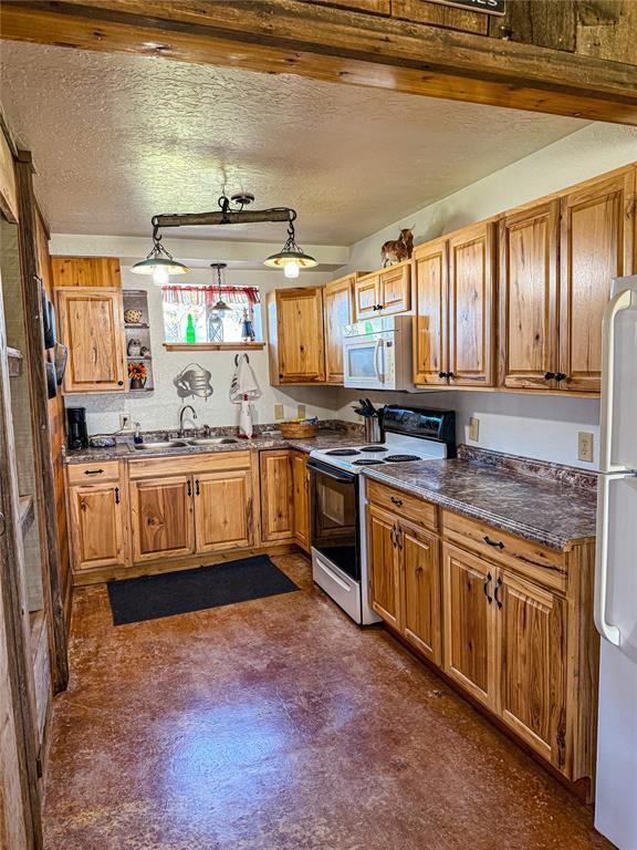 31230 N County Road 3170, Elmore City, OK 73433 - kitchen with a sink, dark countertops, white appliances, open shelves, and brown cabinetry