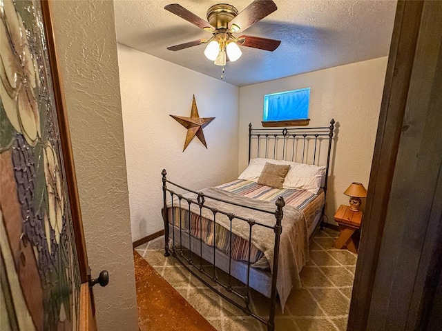 31230 N County Road 3170, Elmore City, OK 73433 - bedroom with a textured wall, a textured ceiling, a ceiling fan, and baseboards