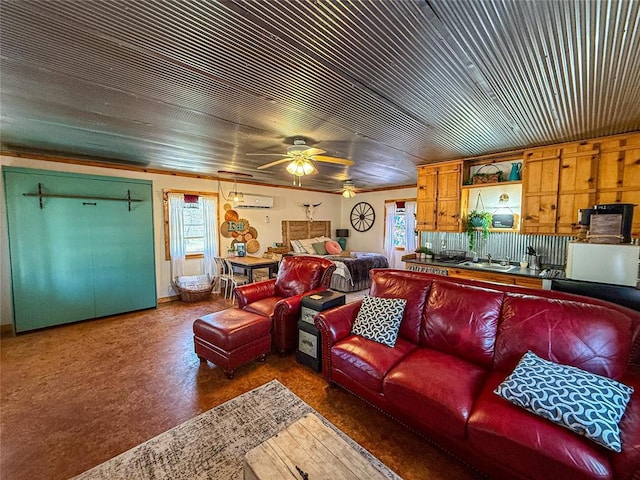 31230 N County Road 3170, Elmore City, OK 73433 - living room featuring a ceiling fan, a wall mounted AC, and a healthy amount of sunlight