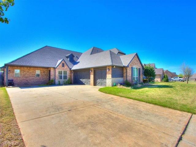 15213 Wilford Way, Edmond, OK 73013 - view of front of home featuring a front yard, stone siding, a garage, concrete driveway, and brick siding