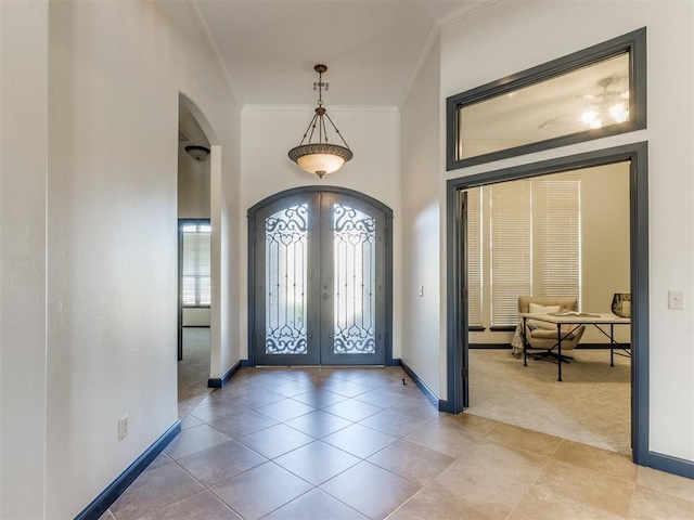 15213 Wilford Way, Edmond, OK 73013 - entryway with arched walkways, french doors, ornamental molding, and a healthy amount of sunlight