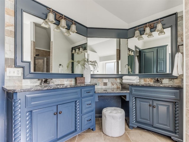 15213 Wilford Way, Edmond, OK 73013 - full bathroom with a sink, double vanity, vaulted ceiling, tile patterned floors, and tiled shower
