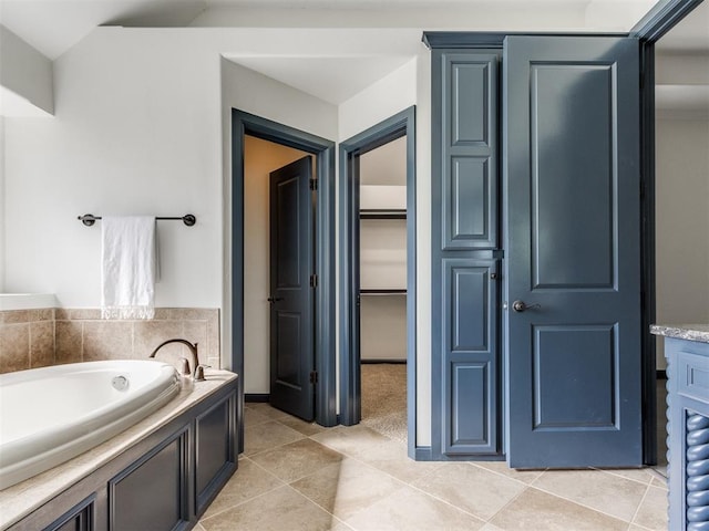 15213 Wilford Way, Edmond, OK 73013 - full bathroom featuring a walk in closet, tile patterned flooring, and a garden tub