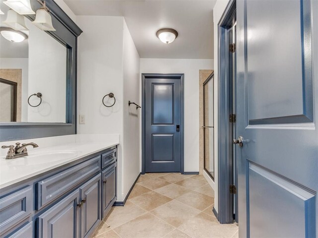 15213 Wilford Way, Edmond, OK 73013 - full bathroom featuring tile patterned floors, vanity, baseboards, and a stall shower