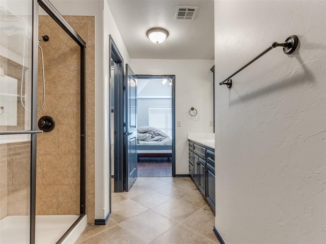 15213 Wilford Way, Edmond, OK 73013 - bathroom featuring vanity, tile patterned flooring, ensuite bathroom, a shower stall, and visible vents