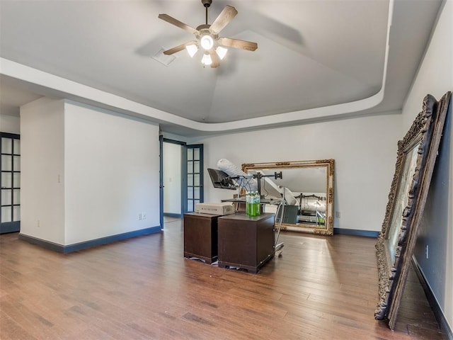 15213 Wilford Way, Edmond, OK 73013 - office featuring a tray ceiling, baseboards, wood finished floors, and ceiling fan