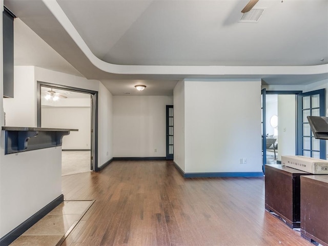 15213 Wilford Way, Edmond, OK 73013 - unfurnished living room featuring wood finished floors, baseboards, and a ceiling fan