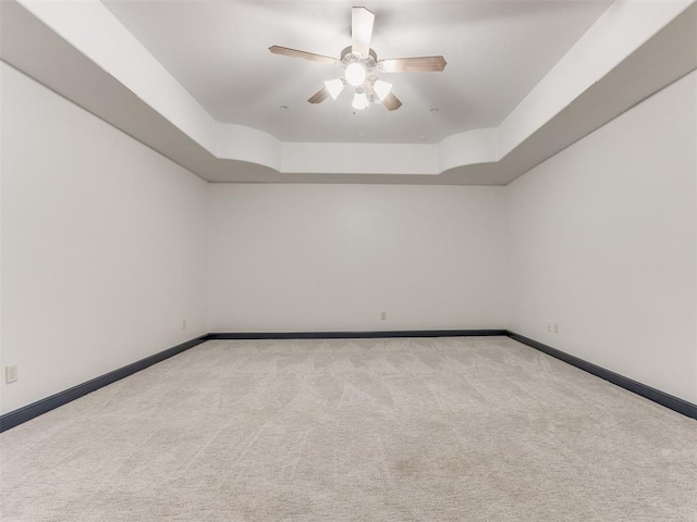 15213 Wilford Way, Edmond, OK 73013 - carpeted empty room with ceiling fan, baseboards, and a raised ceiling