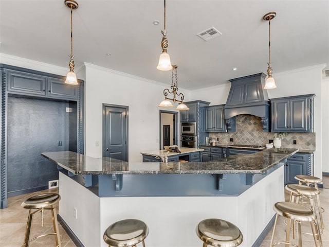 15213 Wilford Way, Edmond, OK 73013 - kitchen featuring a large island, ornamental molding, premium range hood, visible vents, and appliances with stainless steel finishes