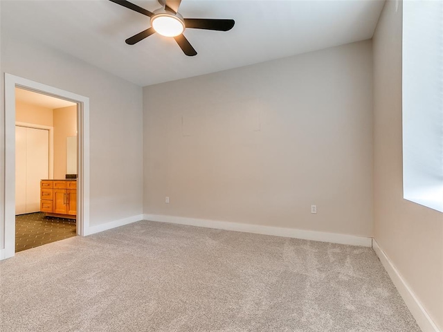 interior space with baseboards and a ceiling fan