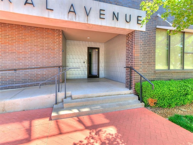 view of exterior entry with brick siding