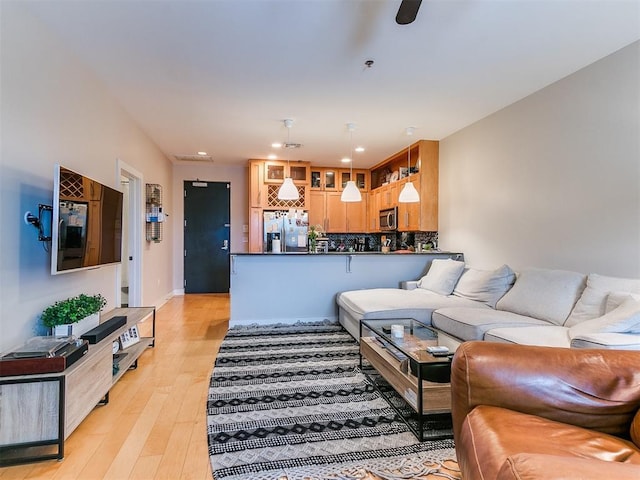 living room featuring recessed lighting and light wood-style floors