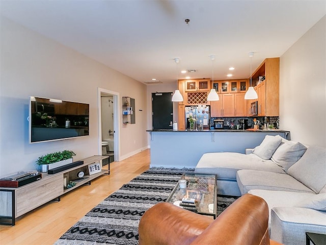 living room with recessed lighting and light wood-style floors
