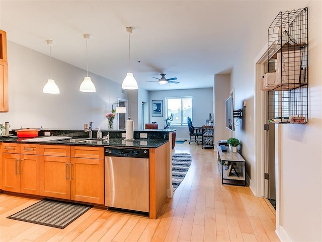 kitchen with brown cabinets, light wood-style flooring, ceiling fan, dishwasher, and hanging light fixtures