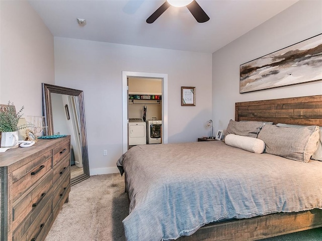 bedroom with baseboards, light colored carpet, washer and dryer, ceiling fan, and a walk in closet