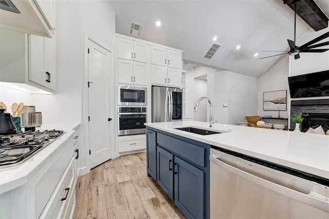 kitchen featuring appliances with stainless steel finishes, white cabinetry, visible vents, ceiling fan, and a sink