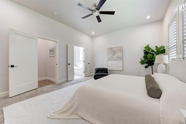 carpeted bedroom with ensuite bath, baseboards, a ceiling fan, and recessed lighting