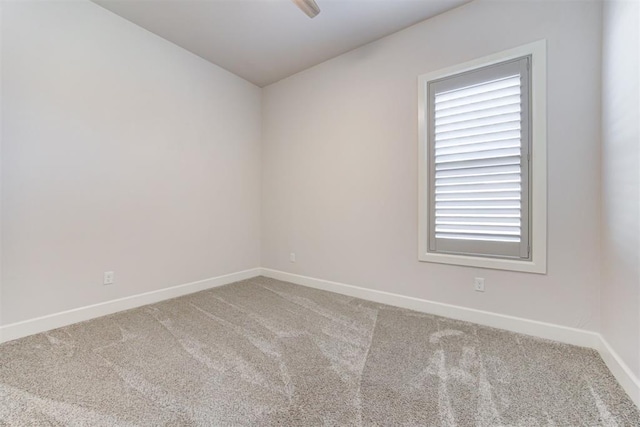 spare room with carpet flooring and baseboards