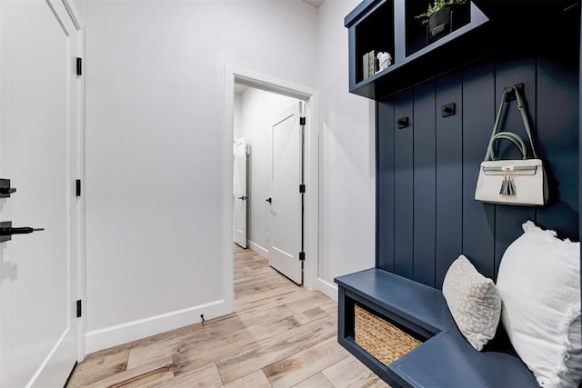mudroom with wood finished floors and baseboards