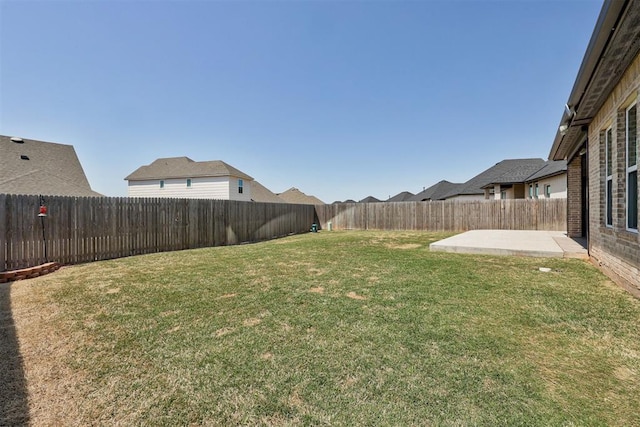 view of yard with a patio area and a fenced backyard