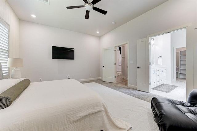 bedroom featuring baseboards, recessed lighting, ensuite bathroom, ceiling fan, and light colored carpet