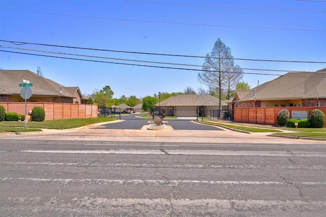 4408 32nd Pl, Oklahoma City, OK 73112 - view of road featuring curbs, a residential view, a gated entry, and sidewalks