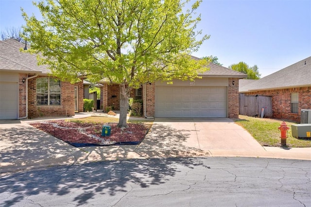 4408 32nd Pl, Oklahoma City, OK 73112 - view of front facade featuring a garage, brick siding, concrete driveway, and a shingled roof
